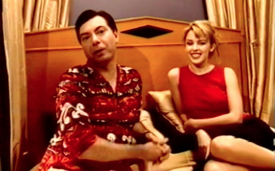 Kylie Minogue with Maynard on bed for interview 1997