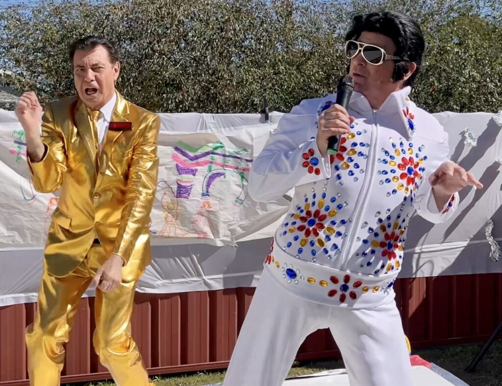 Maynard dances onstage with Fat Elvis. A Very Maynard Xmas 2025